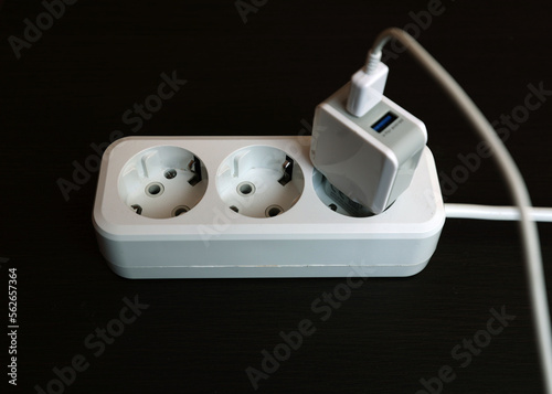 Socket with three connectors for equipment. The carrier is white