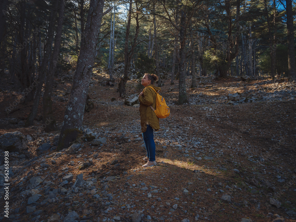 caucasian woman enjoys being in nature,