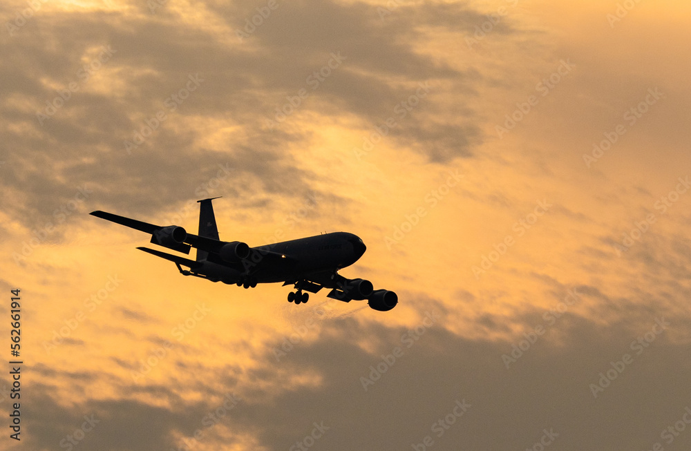 Airplane flying in the sunset sky