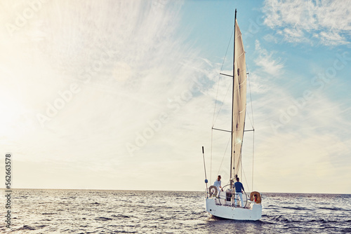 Couple sailing on yacht, adventure and travel with nature, luxury vacation on the ocean for summer holiday. Wealthy people out at sea, lifestyle with blue sky, romantic getaway with seascape mockup © Grady R/peopleimages.com