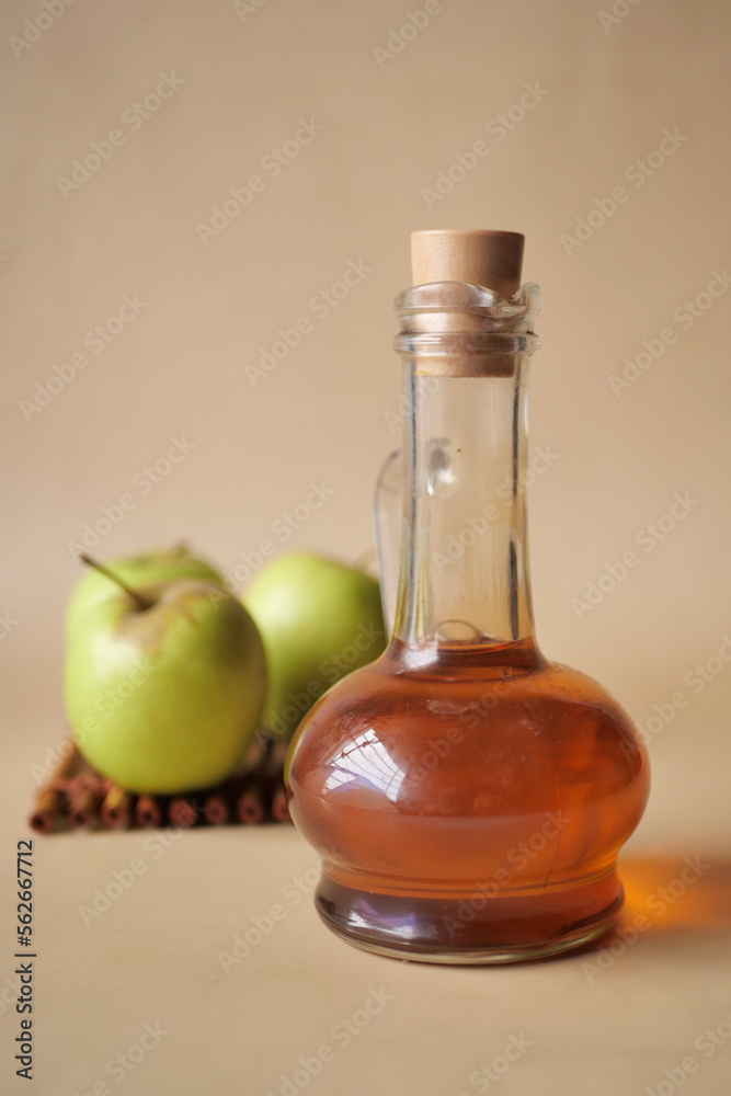 apple vinegar in glass bottle with fresh green apple on table 