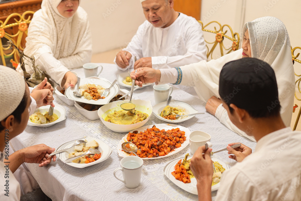 Family togetherness at Eid moment celebration in dining room. 