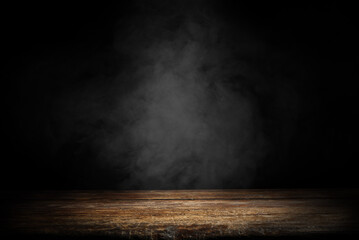 Dark empty wooden table with smoke float up on dark wall background. Free space for your decoration. 