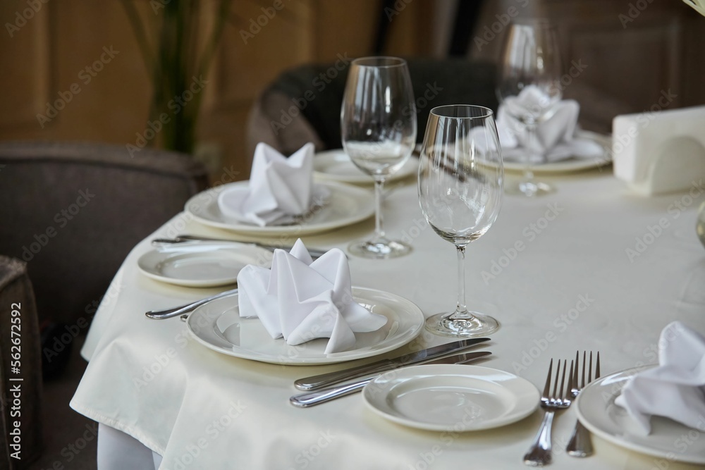 Crystal glasses for celebration, decorated for the holiday. Table setting.