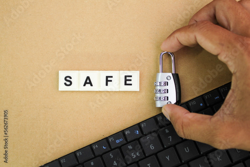 laptop keyboard, holding the key with the alphabetic word safe. cyber security concept.