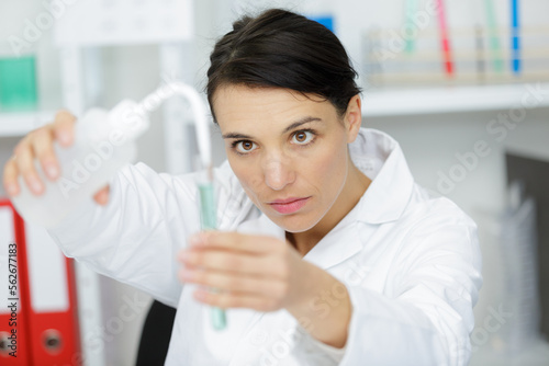 woman working with pipettes and tubes photo