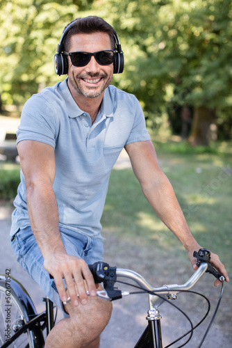 handsome hipster enjoying ride by bicycle