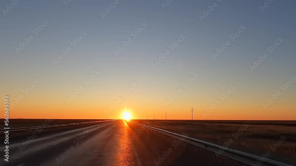 Dawn in the Kazakh steppe. Traveling by car along the highway in Kazakhstan. Morning bright warm sun. Calm calming natural background. Dawn in the Kazakh steppe. Traveling by car along the highway in Kazakhstan. Morning bright warm sun. Calm calming natural background.