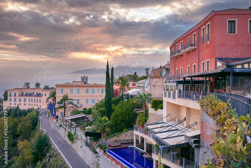 Obraz na płótnie Taormina, Sicily, Italy. Cityscape image of picturesque town of Taormina, Sicily with volcano Etna in the background at sunset. w salonie