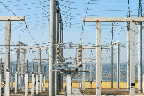 Part of high-voltage substation on blue sky background with switches and disconnectors. Ukrainian energy infrastructure.