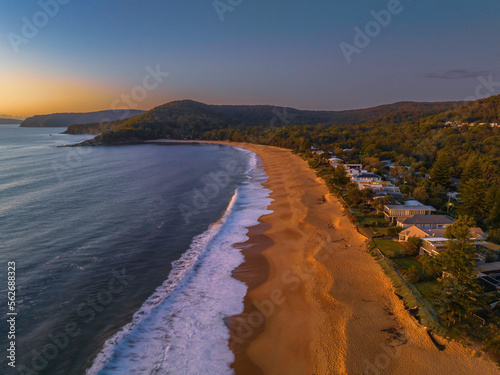 Aerial sunrise seascape with clear skies and low cloud bank