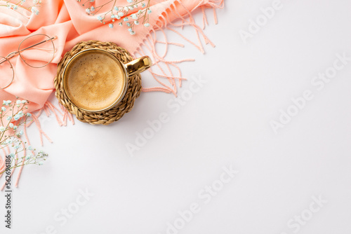 Hello spring concept. Top view photo of cup of frothy coffee on wicker serving mat pink plaid stylish glasses and gypsophila flowers on isolated white background with blank space