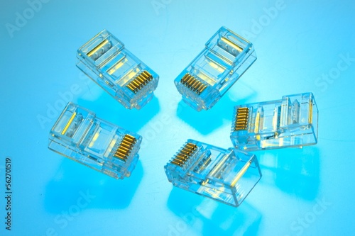 Connector rg 45 for internet cable. Several connectors lie on a multi-colored background. Close-up photo