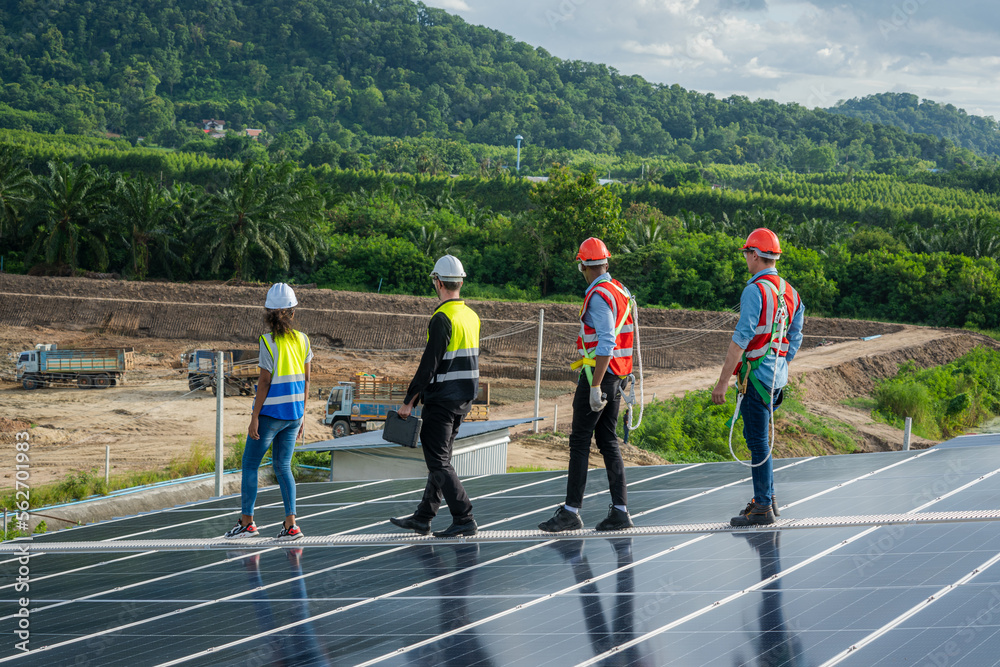 Engineer maintenance checking installing solar roof panel on the factory rooftop,Survey check solar panel roof. Engineer maintenance checking installing solar roof panel on the factory rooftop,Survey check solar panel roof.