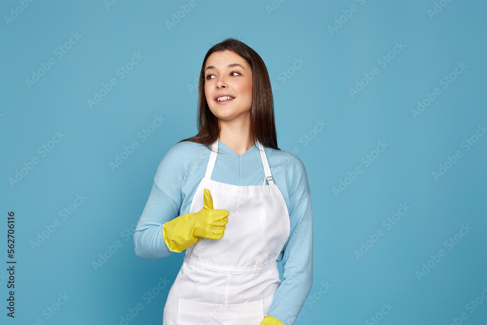 woman in rubber gloves and cleaner apron showing ok sign woman in rubber gloves and cleaner apron showing ok sign