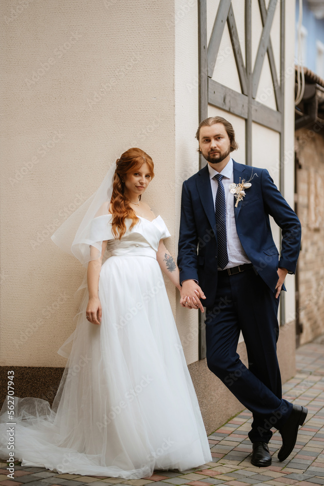 young couple bride and groom in a white dress young couple bride and groom in a white dress