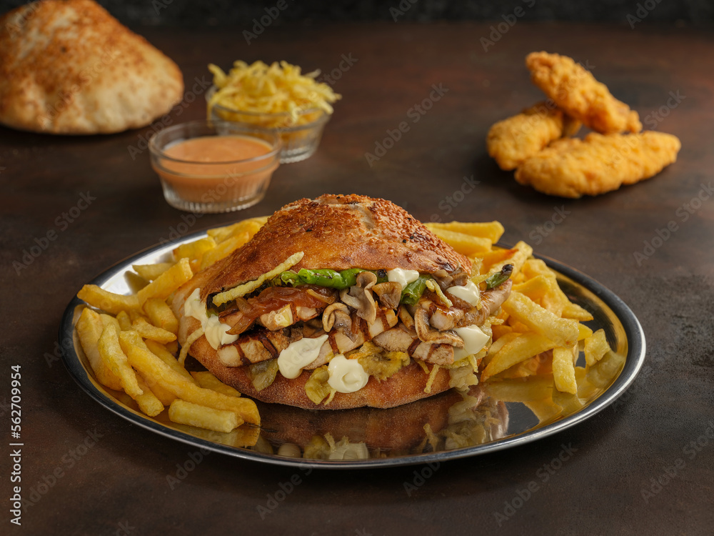 Delicious hamburger and french fries on wooden background Delicious hamburger and french fries on wooden background