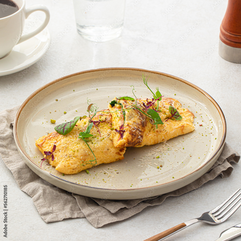 Portion of gourmet omelette with avocado and salmon