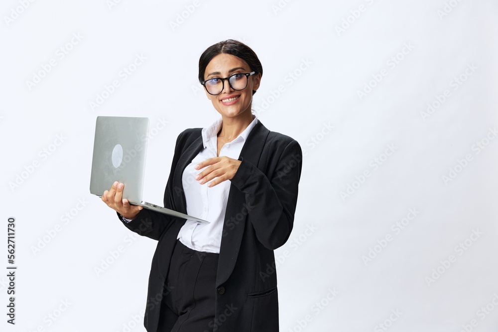 Business woman with laptop in hand in black business suit shows signals gestures and emotions on white background, freelancer job online training Business woman with laptop in hand in black business suit shows signals gestures and emotions on white background, freelancer job online training
