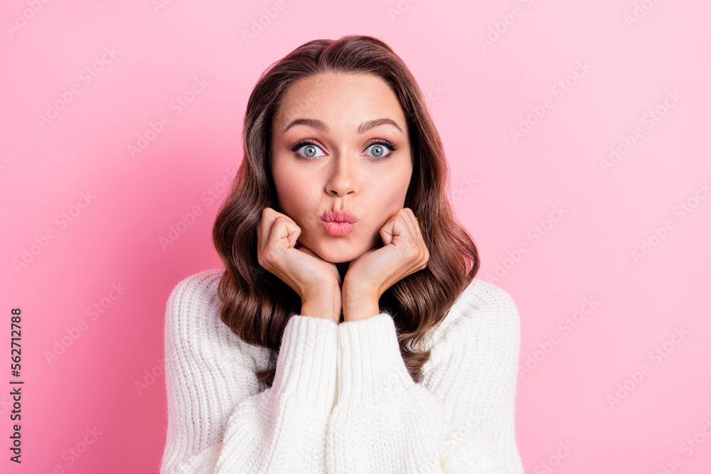 Photo of stunning person hands touch cheeks pouted lips kiss isolated on pink color background Photo of stunning person hands touch cheeks pouted lips kiss isolated on pink color background