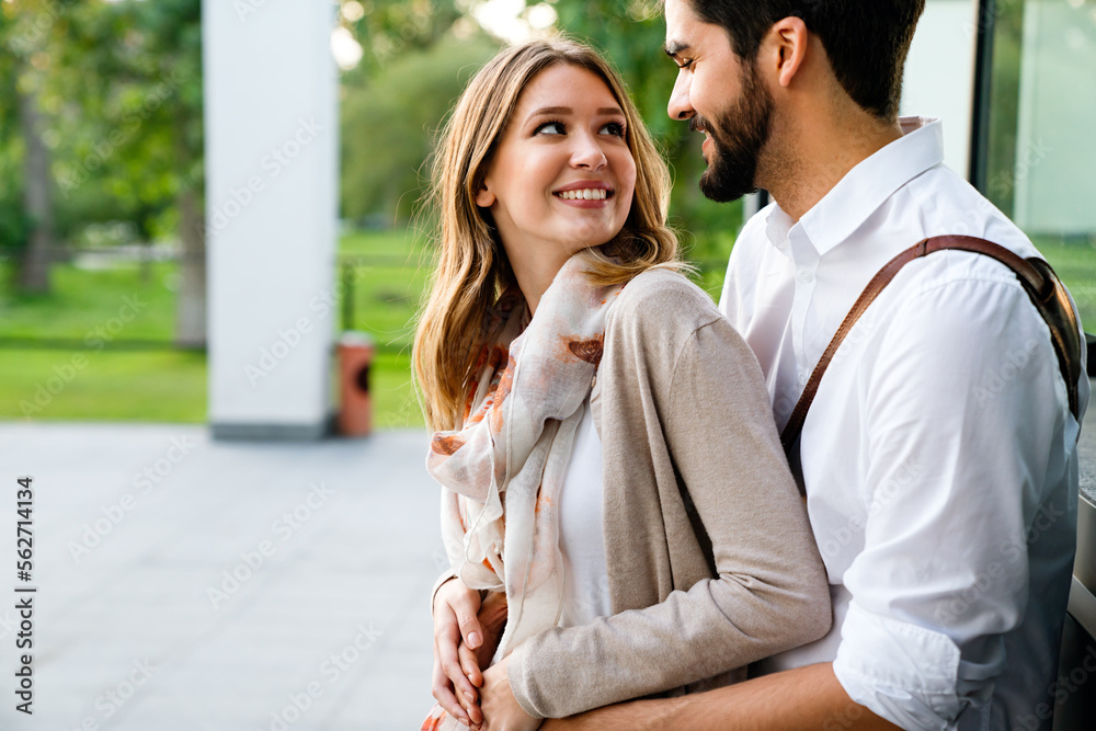 Close up of a smiling beautiful young couple embracing while standing outdoors. Close up of a smiling beautiful young couple embracing while standing outdoors.