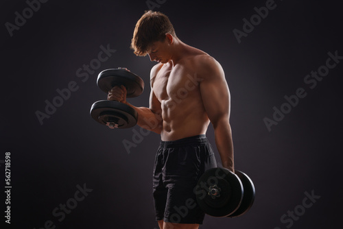 Canvastavla Young handsome sportsman bodybuilder weightlifter with an ideal body, after coaching poses in front of the camera, abdominal muscles, biceps triceps