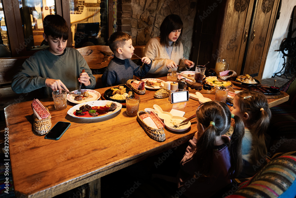 Family having a meal together in authentic ukrainian restaurant.