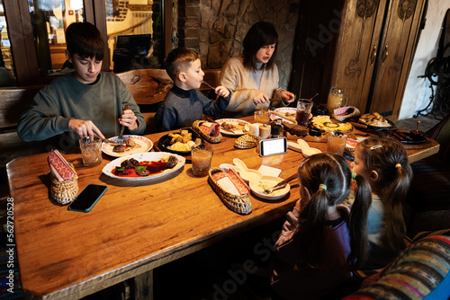 Family having a meal together in authentic ukrainian restaurant.