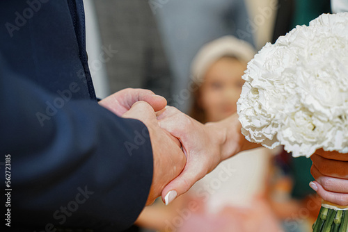 Wedding rings in the hands of the bride and groom.
