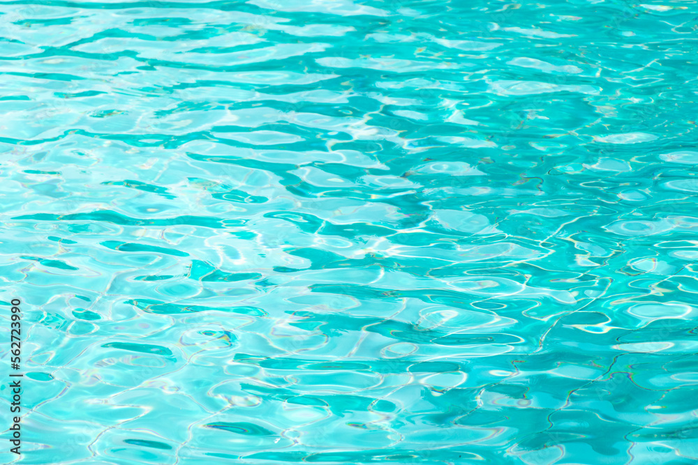 Ripple Water in swimming pool with blue tile floor background Ripple Water in swimming pool with blue tile floor background