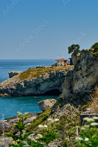 Istanbul, Turkey. The rocky shore of the Black Sea with a cave in Sile, beautiful villas on a hill.