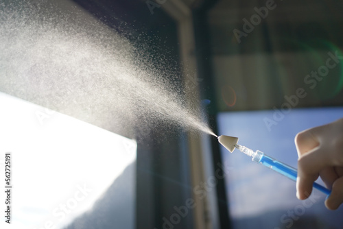 Nebulizing a drug for intranasal application with a mucosal atomization device on a syringe.  photo