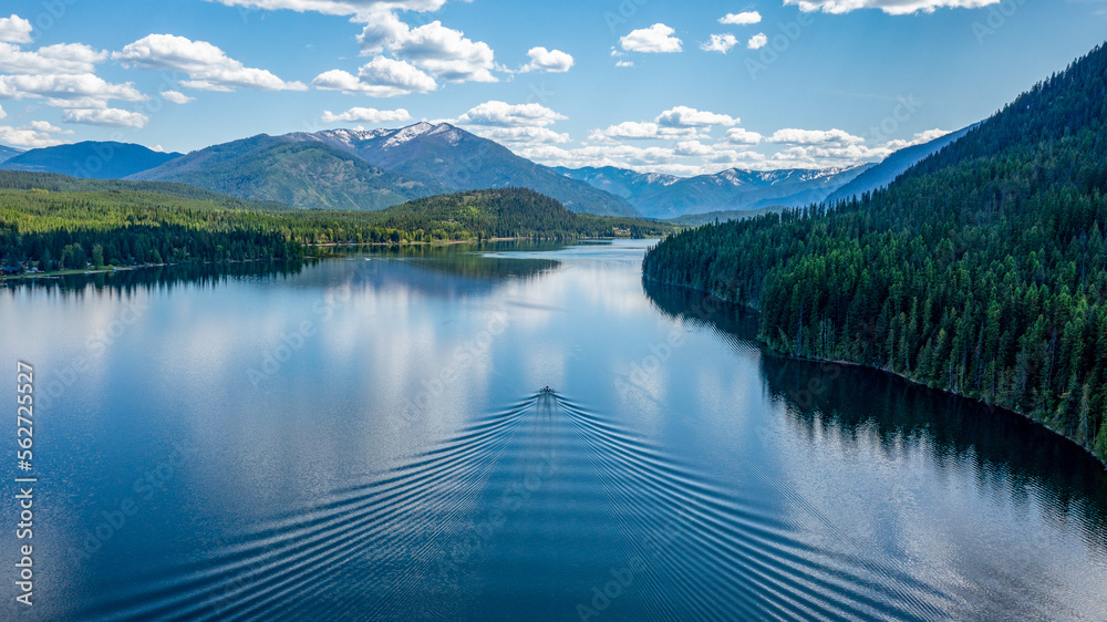 A afternoon capture of single boat on the beautiful Bull Lake in Northwest Montana. A afternoon capture of single boat on the beautiful Bull Lake in Northwest Montana.