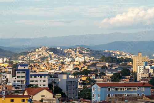 Amazing metropole with houses on small hills and horizon with mountains