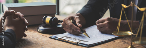 A young Asian lawyer or legal advisor clarifies information about business deals. The signing of investment contracts in accordance with laws and regulations. photo