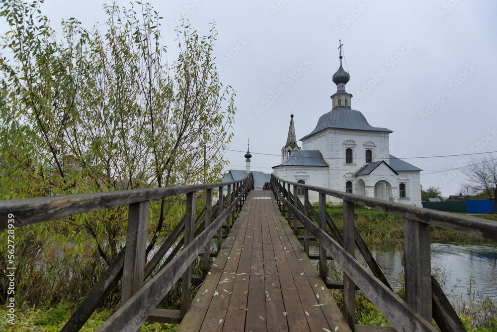 Cityscape of Suzdal, Russia. Wooden bridge across the Kamenka river