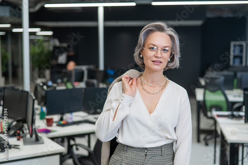 Portrait of an attractive mature caucasian woman in the office. 