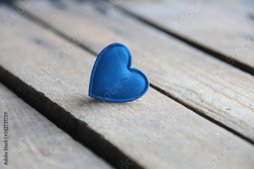 Blue heart on a wooden background. Place for text. Valentine. Birthday background.