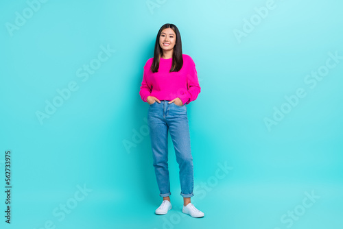 Full length photo of confident charming lady wear pink sweater walking smiling isolated turquoise color background