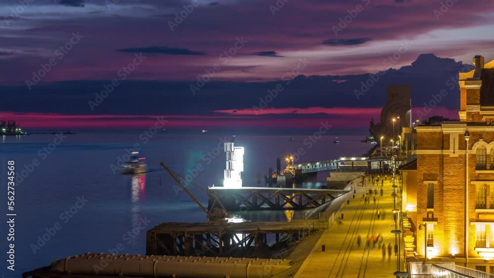 Waterfront view with the Padrao dos Descobrimentos (Monument to the Discoveries) day to night transition timelapse. Famous monument on the banks of the River Tagus in Lisbon with colorful clouds