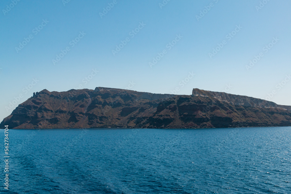 Therasia island in Santorini caldera - view from boat
