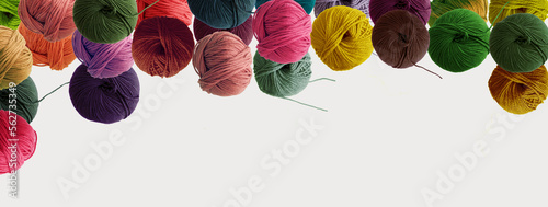 Balls of wool colored yarn for hand knitting and crochet on white background. Recomforting winter hobby concept. Mock up, flat lay, copy space, banner.