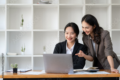 Business idea creative brainstorming sessions for projects Strategic topic of two Asian girls working together data analysis Happy clarification of various financial information at the desk.
