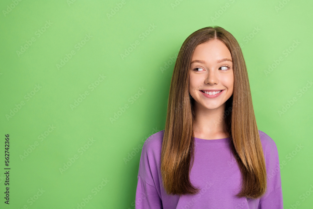 Photo of pretty lovely lady wear trendy clothes interested look empty space nice discounts isolated on green color background Photo of pretty lovely lady wear trendy clothes interested look empty space nice discounts isolated on green color background