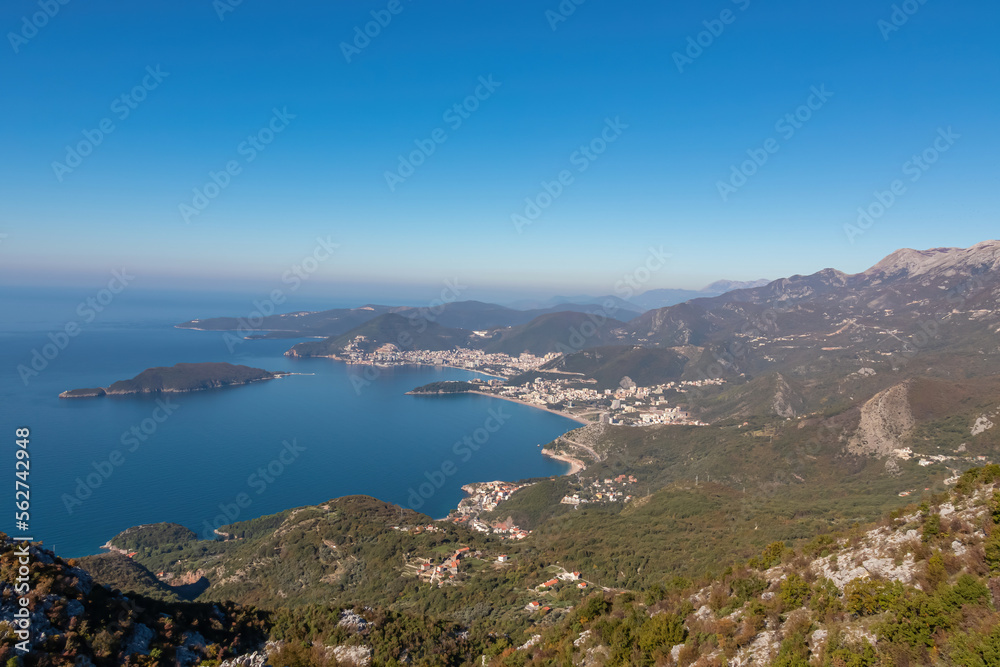 Panoramic aerial view on the coastline of Budva and Sveti Nikola Island seen from Goli Vrh, Adriatic Mediterranean Sea, Montenegro, Balkan, Europe. Luxury hotel resorts along Budvanian Riviera.