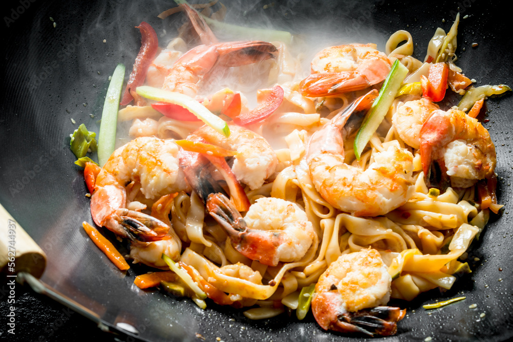 Chinese wok. Hot Udon noodles with shrimp, sauce and vegetables. Chinese wok. Hot Udon noodles with shrimp, sauce and vegetables.