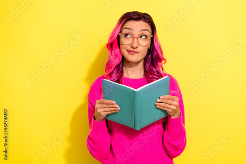 Photo of pretty suspicious lady wear vivid sweater enjoying book looking empty space isolated yellow color background