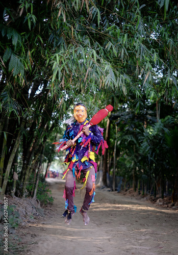 Hindu religious village people celebrating gajan festival wearing colourful costumes photo