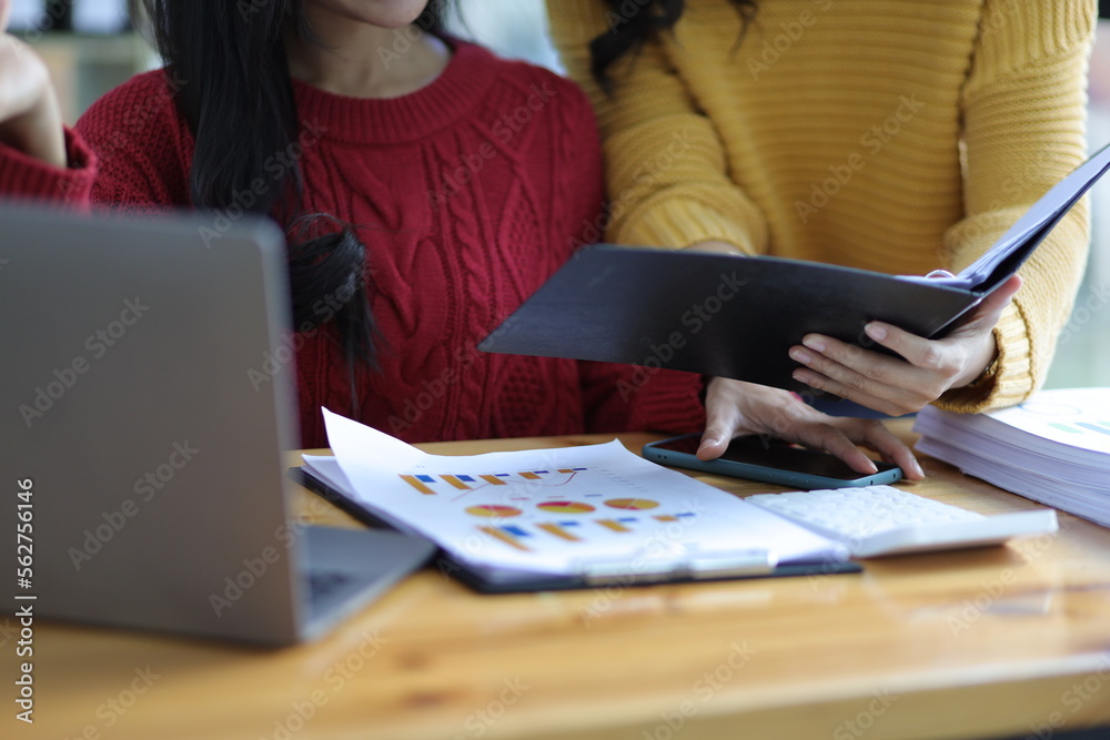 Colleagues work at their office desks together checking documents. Accountants discuss budget accounting and financial planning. Colleagues work at their office desks together checking documents. Accountants discuss budget accounting and financial planning.