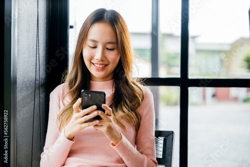 Asian young woman hands holding mobile phone at cafe coffee shop, Happy beautiful female typing text message on smart phone device and enjoyment lifestyle with social networking media